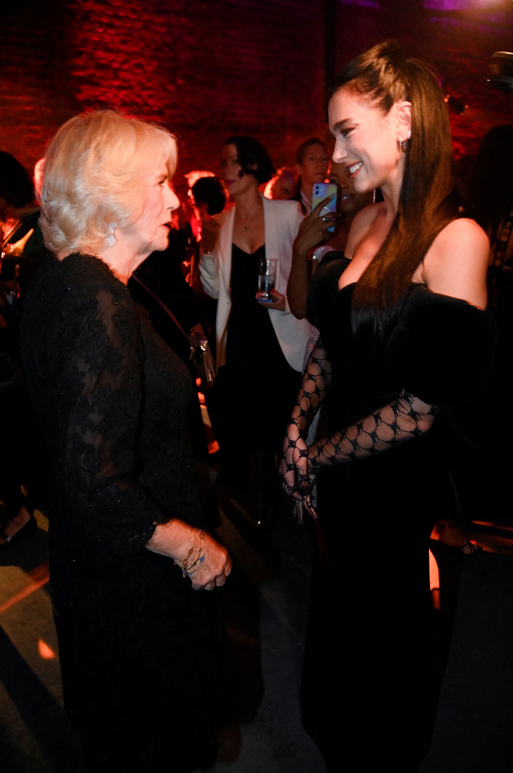 LONDON, ENGLAND - OCTOBER 17: Camilla, Queen Consort meets singer Dua Lipa at the 2022 Booker Prize for Fiction ceremony at the Roundhouse, on October 17, 2022, in London, England. (Photo by Toby Melville - WPA Pool/Getty Images)