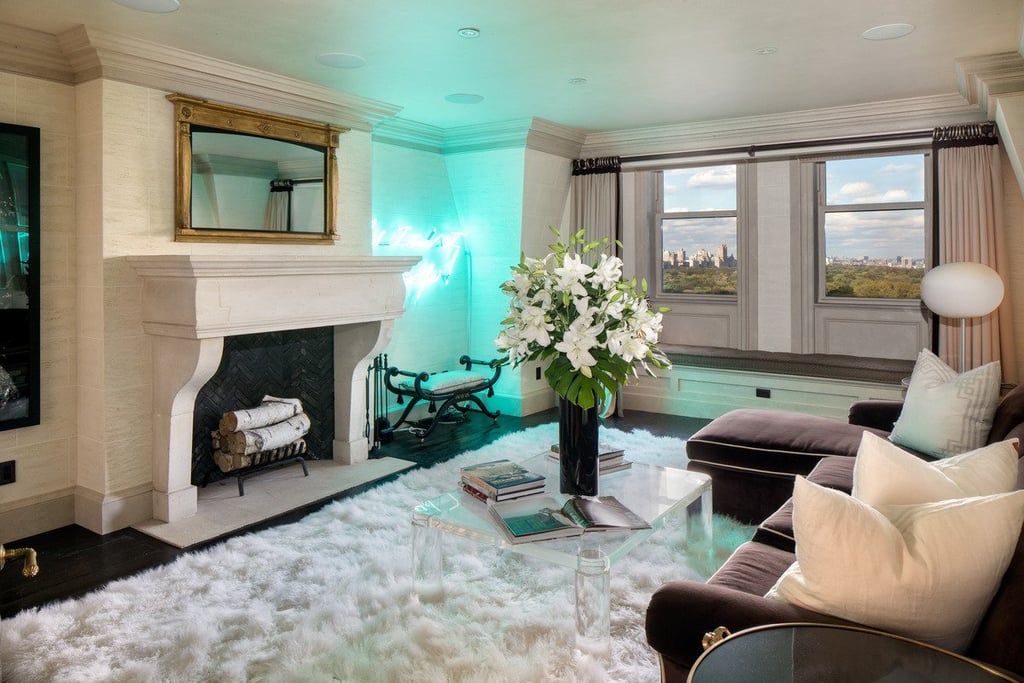 This informal living room combines a mix of modern and traditional decor elements, including an unexpected green neon light.
