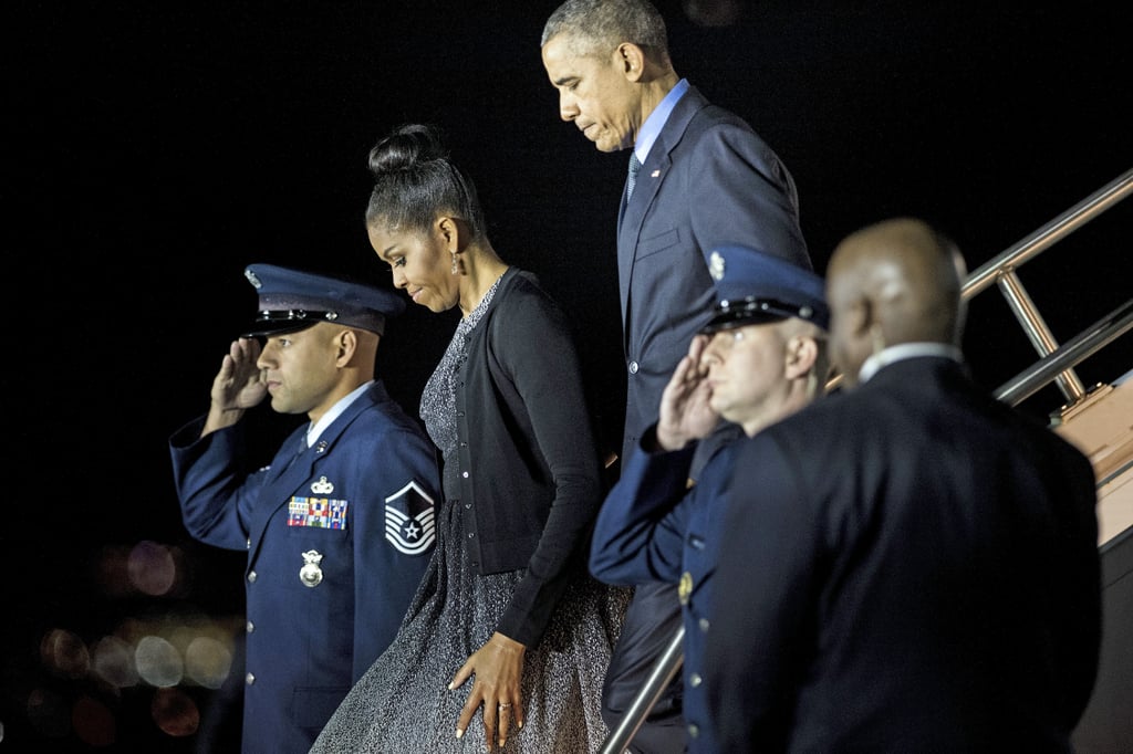 Michelle completed her faded gray dress with a black cardigan.