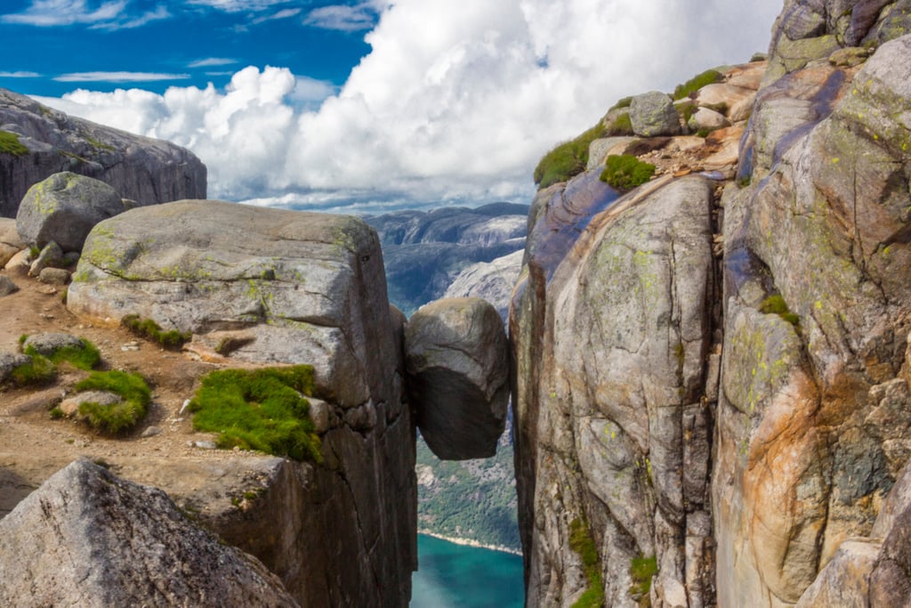Stand on a Boulder Wedged Between Mountains in Norway