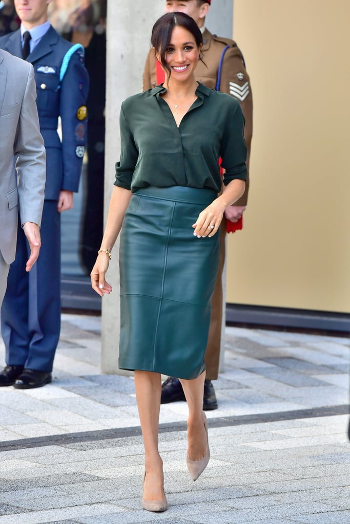 While her "Suits" character generally gravitated toward all-neutral looks, Markle doesn't shy away from bright colors. Back in 2018, she rocked a leather pencil skirt and loose silk blouse in the same hunter green shade for a royal appearance.