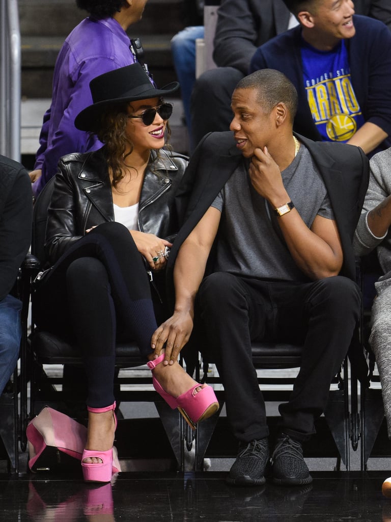 Jay Z held on to Beyoncé's ankle as they checked out the Golden State Warriors game in February 2016.