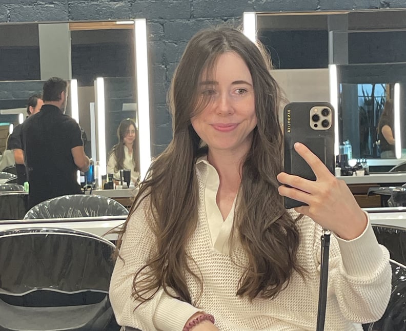Author with hair middle-parted and styled with loose waves