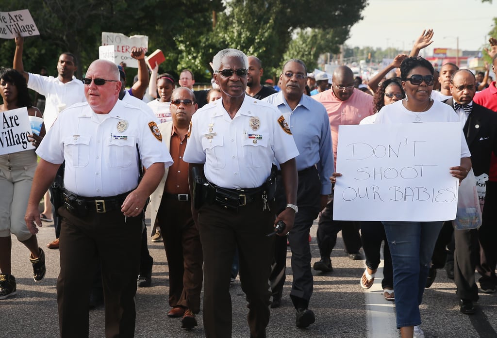 Police officers marched alongside demonstrators in Ferguson, MO. Police officers marched alongside demonstrators in Ferguson, MO.