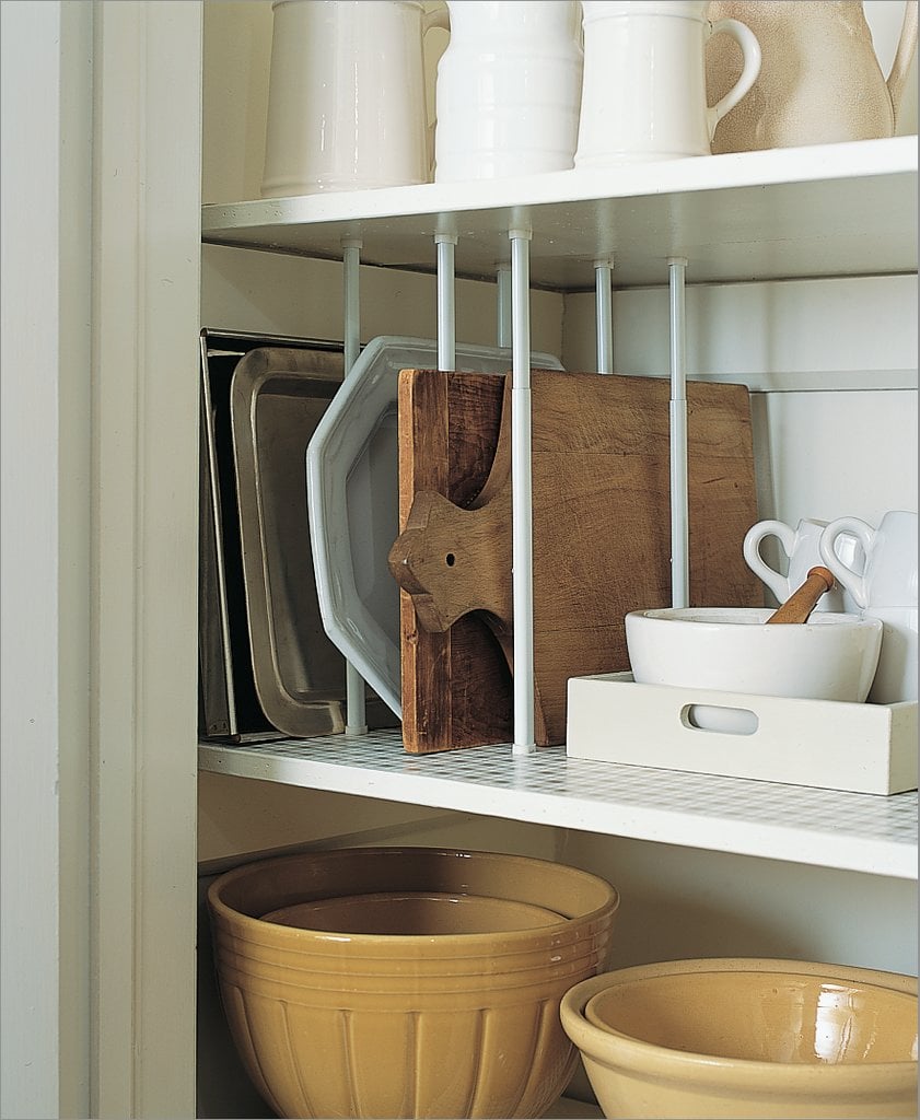 Keep cutting boards and trays easily accessible by installing tension rods.