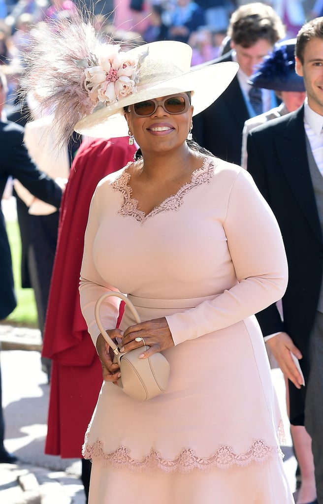 Oprah Winfrey was one of the lucky celebrities who had the honor of attending the royal wedding on May 19, and naturally, she is still raving about it. On Monday, the media mogul gushed to ET during the LA premiere of her new series, Love Is __, about the "transformative" experience. "It was more than a wedding, I thought," Oprah explained. "It was a cultural moment. You could not be there or watching on television and not feel that there was a shift that just happened in the middle of it. I think it's bigger than them and I think it bodes well for hope for all of us."
Oprah also opened up about her newly formed friendship with Meghan's mom, Doria Ragland, and addressed reports that she was trying to bribe her for an interview. "The story was that Meghan's mom had come to my house and she left laden with gifts," Oprah said. "You know what the gifts were? First of all, she's great at yoga, so I said, 'Bring your yoga mat and your sneaks in case we just want to do yoga on the lawn.' So one of the bags was a yoga mat and the other was lunch. She said, 'I love kumquats,' and I said, 'I have a kumquat tree! You want some kumquats?' So it was a basket of kumquats, people. If kumquats can get you an interview, I'm all for it!" 
OK, so now how do we score an invite to Oprah's house?