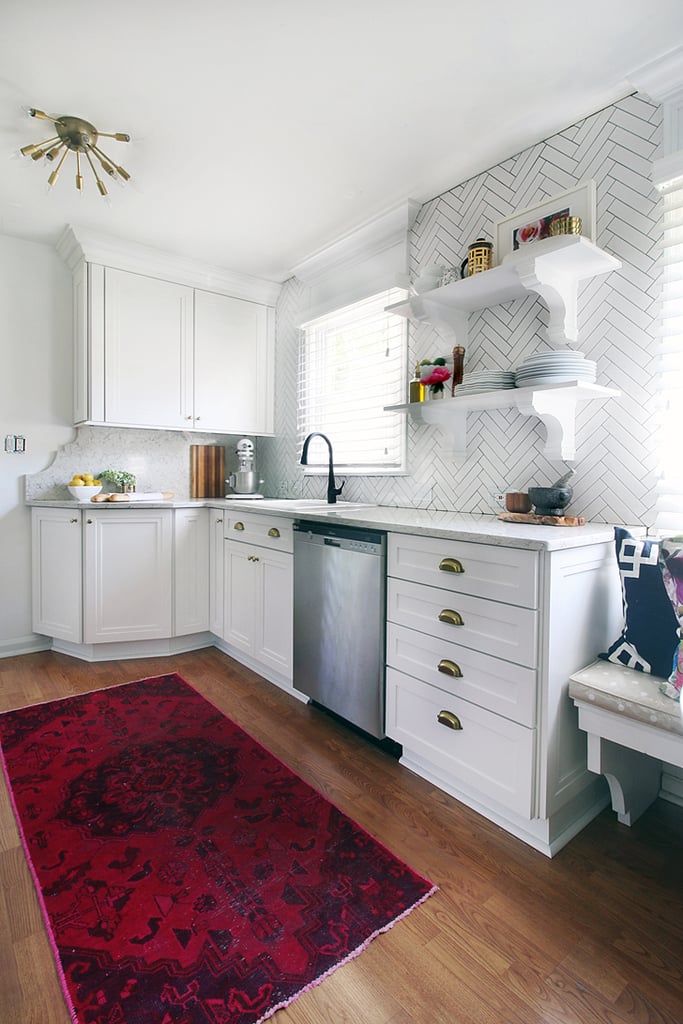 By switching around appliances and extending the cabinets and counter, Kristin made room for open shelves and a stunning herringbone-tiled accent wall.