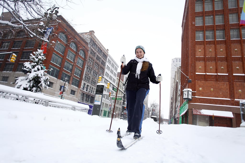A woman skied through the snowy streets of Detroit, MI.