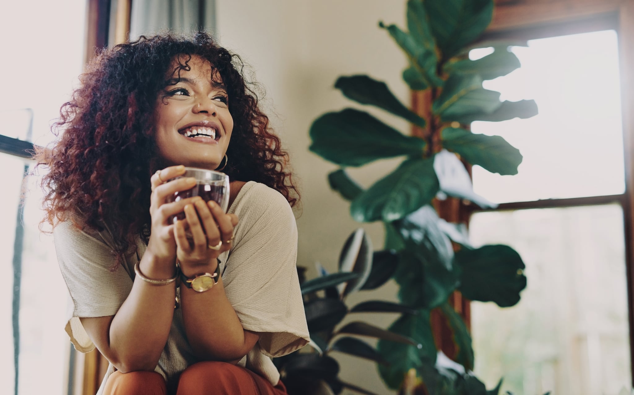 Cropped shot of an attractive young woman drinking tea while relaxing at home