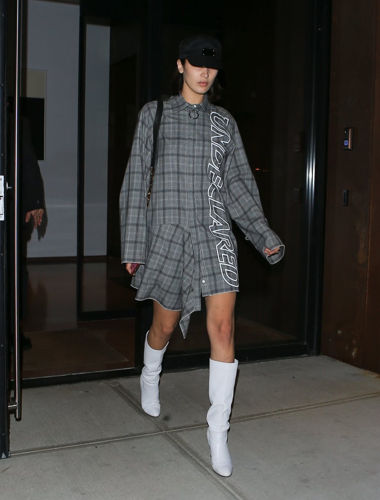 Bella Finished Off NYFW Wearing a Plaid Shirt Dress and White Boots