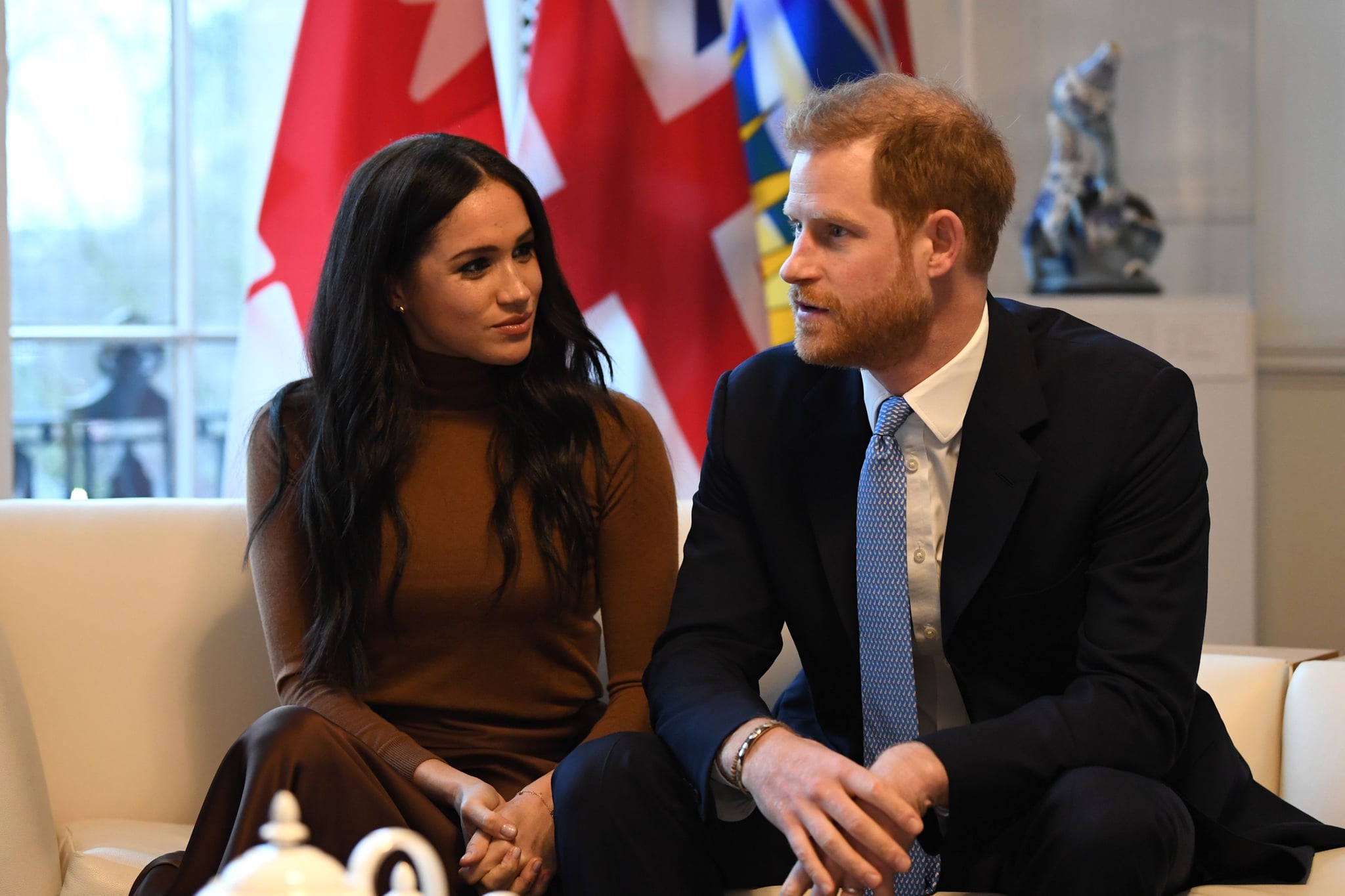 Britain's Prince Harry, Duke of Sussex and Meghan, Duchess of Sussex gesture during their visit to Canada House in thanks for the warm Canadian hospitality and support they received during their recent stay in Canada,  in London on January 7, 2020. (Photo by DANIEL LEAL-OLIVAS / various sources / AFP) (Photo by DANIEL LEAL-OLIVAS/AFP via Getty Images)