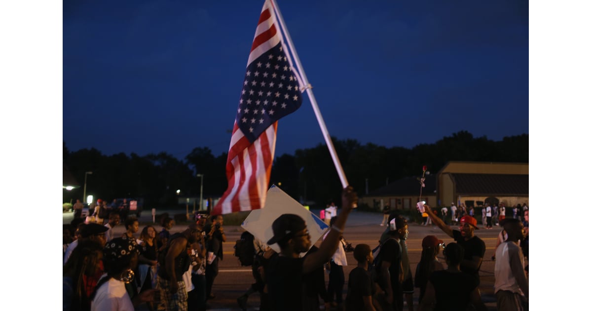 A man held an upsidedown American flag during a protest. Pictures of