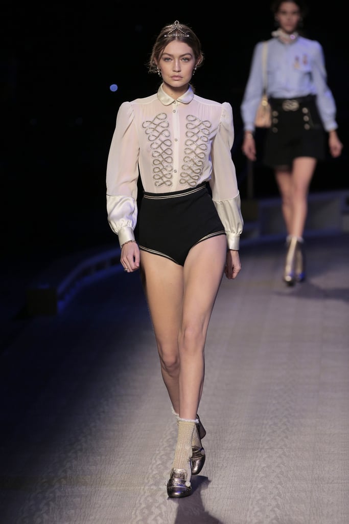 Gigi wore a gilded collared blouse and high-waisted briefs, completing the look with metallic sailor shoes, ornate socks, and a captain-worthy crown.