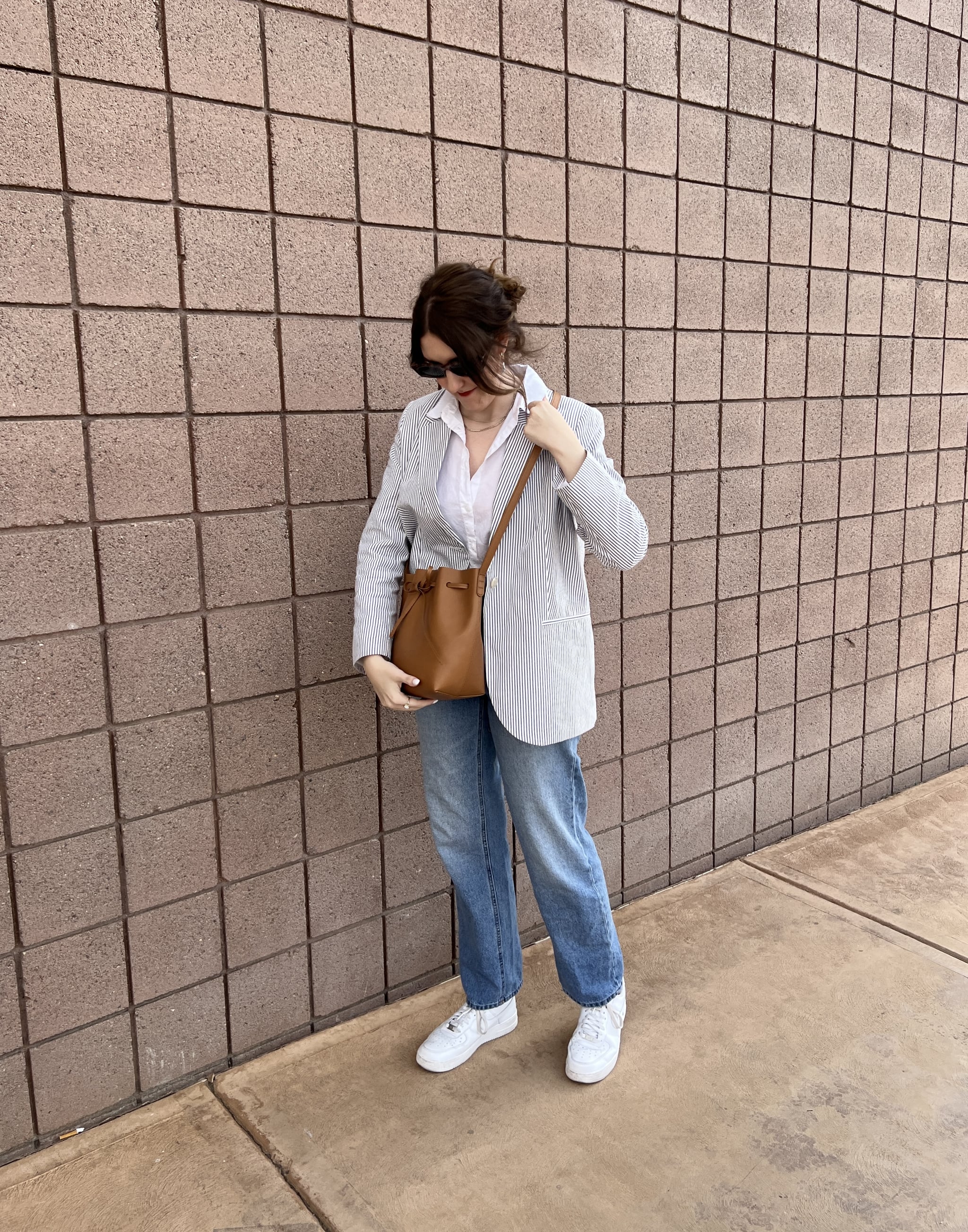 woman carrying Mansur Gavriel Apple Leather Bucket Bag