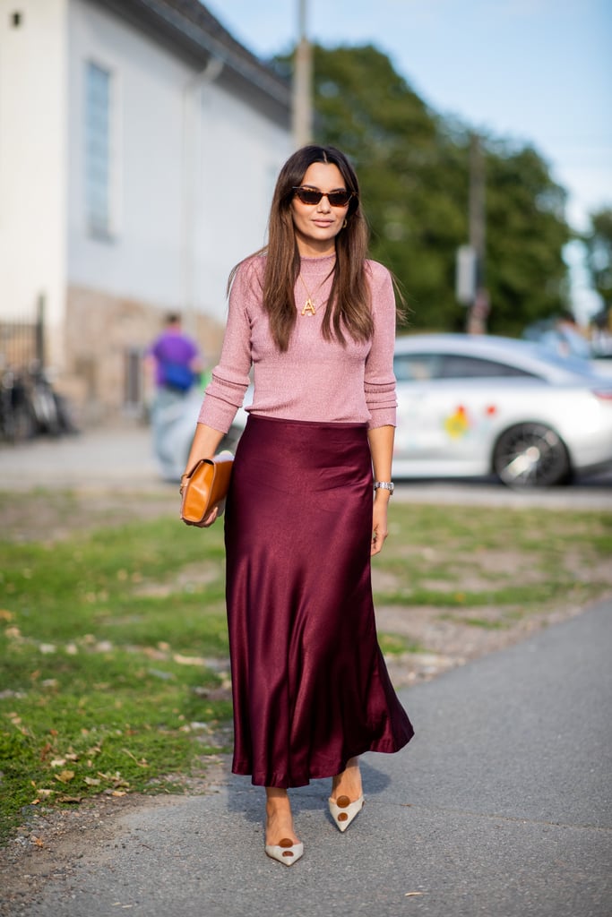 With a slim-fit crewneck sweater and silk midi skirt, you're ready for whatever the day (and night!) might throw at you.
