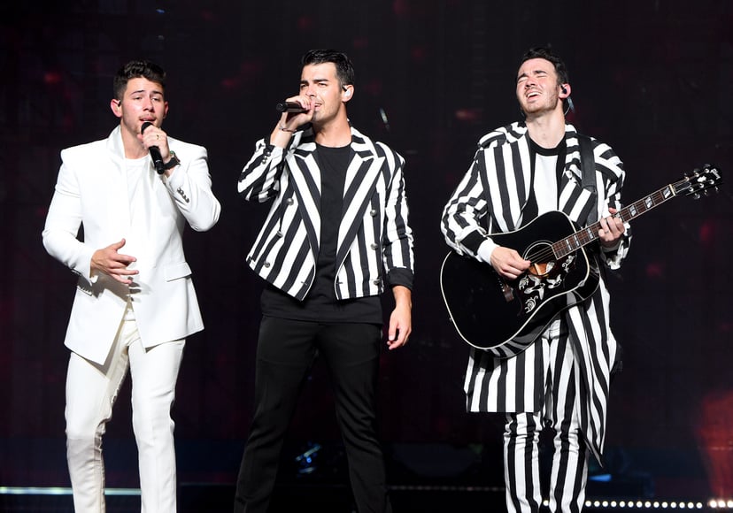 MIAMI, FLORIDA - AUGUST 07: Nick Jonas, Joe Jonas, and Kevin Jonas of The Jonas Brothers perform on stage during their 