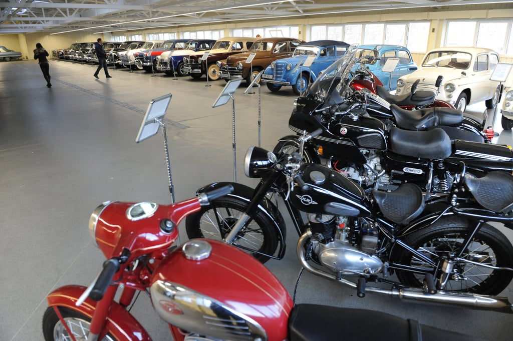 Several motorcycles sat beside the vintage car collection.