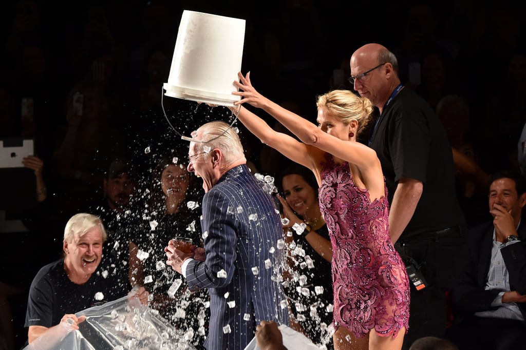 Heidi Klum helped Tim Gunn participate in the ALS Ice Bucket Challenge at the Project Runway show on Friday.