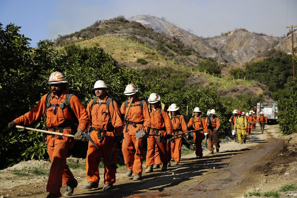Firefighters walked through the foothills of Azusa, CA, while working to fight the blaze.