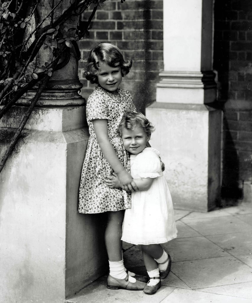 How adorable is this?! Elizabeth and Margaret held on to each other outside their home in 1932.