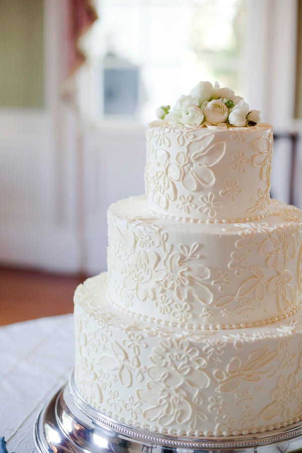 An easy recipe for an elegant cake that's hard to forget? A floral and lace-like pattern that's topped off with white roses. 
Photo by Corbin Gurkin Photography via Style Me Pretty