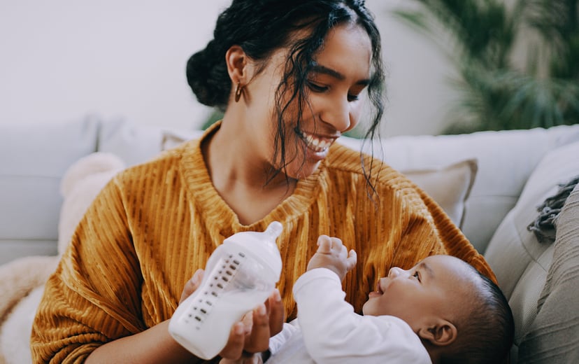 Woman feeding her baby with a bottle of formula