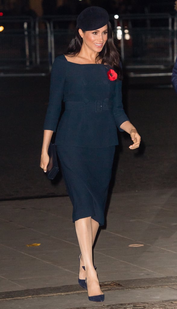 Meghan wore a bespoke skirt suit, reportedly by Prada, in navy blue for 2018 Remembrance Day events.