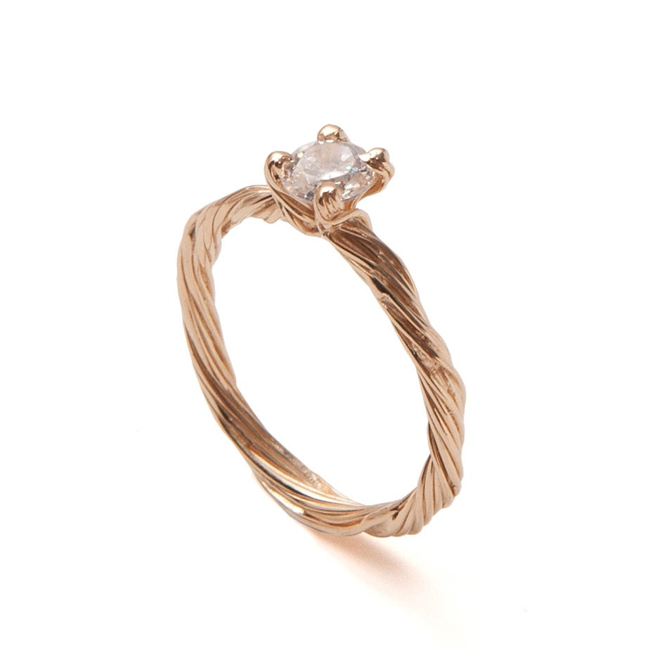 Boho brides will appreciate this handmade 18k yellow gold twig ring ($1,050) set with a clear diamond.