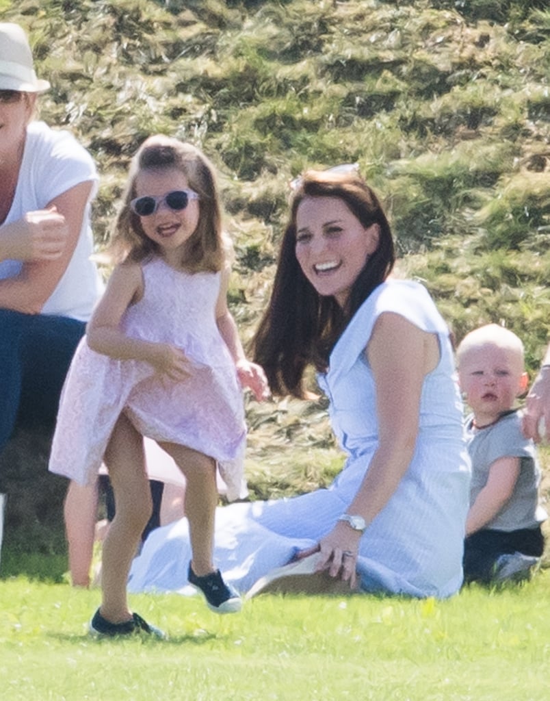 Princess Charlotte had a blast wearing an adorable pink dress, matching sunglasses, and blue plimsolls while watching her dad play polo.