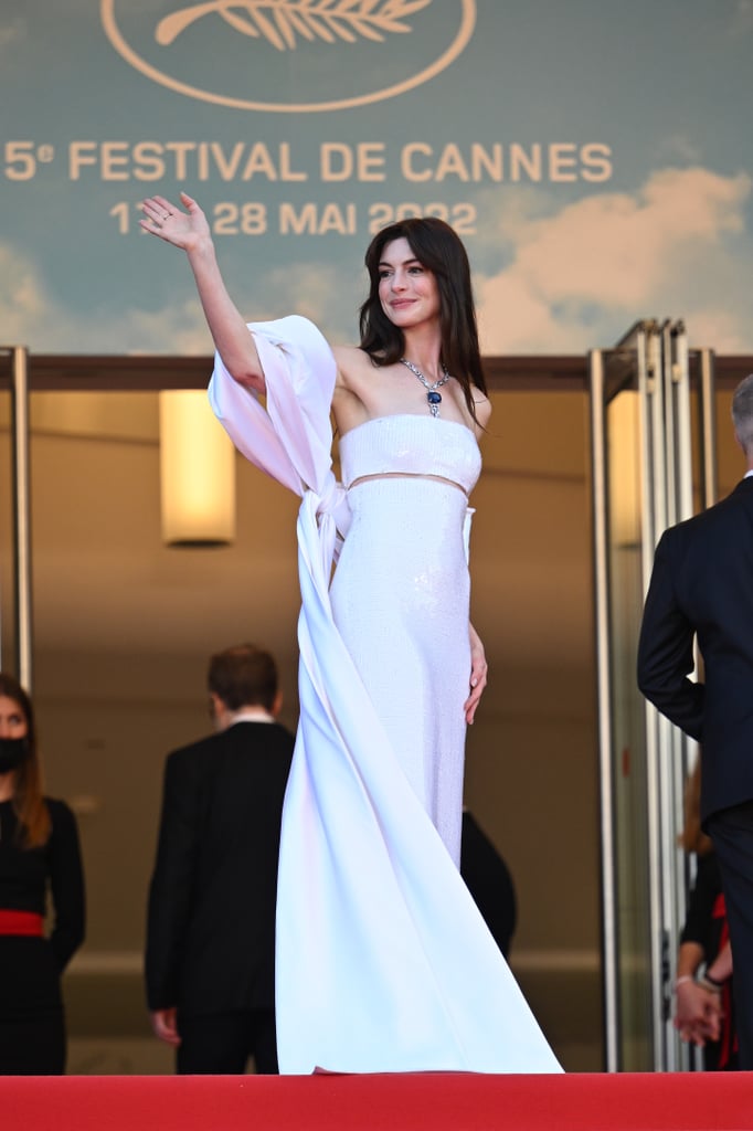 Anne Hathaway made an entrance at the Cannes Film Festival on May 19 while promoting her new film, "Armageddon Time." Hathaway, accompanied by her husband, Adam Shulman, arrived dressed in a custom Armani Privé dress embellished with white sequins. The "WeCrashed" star paired the two-piece dress with a silky shawl that doubled as a train as it trailed behind her. Hathaway styled the strapless look with silver slingback heels and Bulgari jewelry, including a Mediterranean Reverie necklace inlaid with a 100,000-carat sapphire à la Kate Winslet's prized jewel in "Titanic," aka The Heart of the Ocean.
"A red carpet exclusive," the brand wrote on Instagram. "All eyes turn towards the Mediterranean Reverie necklace, a stunning piece from the new Bulgari Eden The Garden of Wonders High Jewelry collection. Showcasing the enchanting splendor of a unique stone — 107,15 dazzling carats of royal blue cushion-cut sapphire from Sri Lanka — this extravagant creation will premiere in Cannes this evening."
Simplistic yet elegant, the look is just one of many examples of Hathaway's fashion versatility. Preceding the festival, she teased a new style direction in a three-piece Christopher John Rogers suit covered in rainbow polka-dots while promoting "WeCrashed." At the global premiere of the Apple TV+ series in March, Hathaway made another style statement in a structural David Koma dress that featured a thigh-high slit and an asymmetrical cutout across the bodice.
Ensuring the necklace was on full display as she waved to the cameras, Hathaway — who's played all manners of royalty, from the White Queen in "Alice in Wonderland" to Princess Mia Thermopolis in "The Princess Diaries" — evoked an undeniable air of opulence on Thursday. See her red carpet ensemble at the Cannes Film Festival ahead.

    Related:

            
            
                                    
                            

            Adriana Lima Shows Off Her Baby Bump in a Clever Cutout Dress