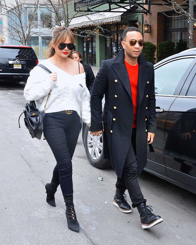 Chrissy walked hand in hand with John Legend wearing an off-the-shoulder white sweater, skinny jeans, and a Gucci belt. She finished off her look with a Chanel backpack and Yeezy boots.
