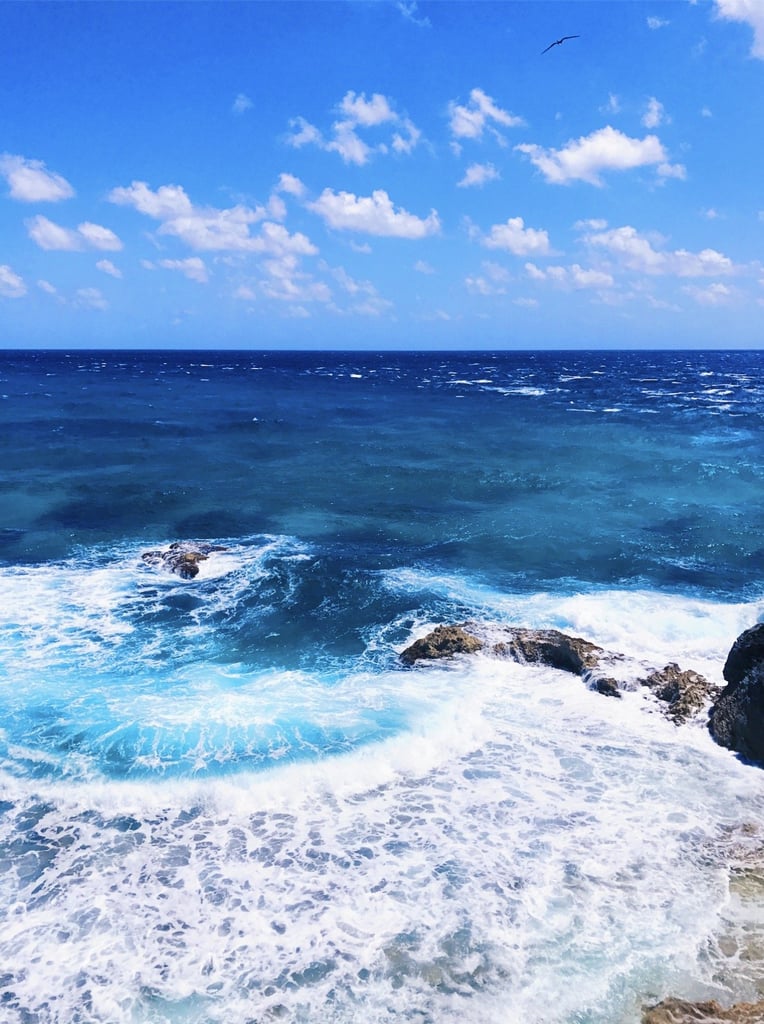 Steep cliffs with breathtaking crystal-clear blue waves crashing ashore makes for the perfect 'grammable shot with your squad.