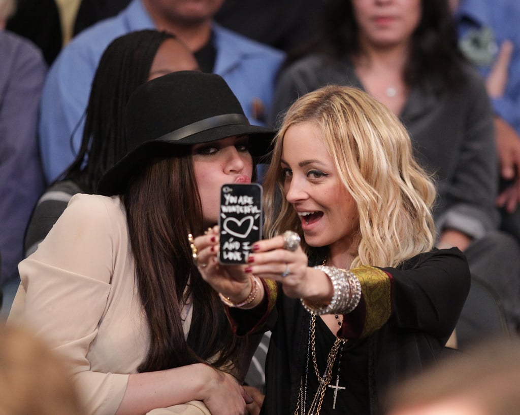 Khloé Kardashian and Nicole Richie took a break from watching a January 2011 Lakers game to pose for a picture courtside.