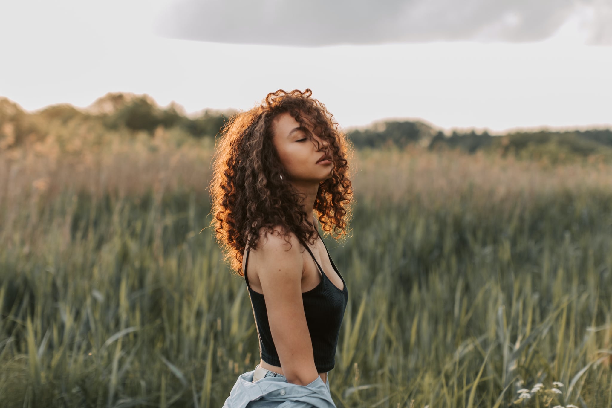 woman in a field finding balance as representation of the september libra new moon