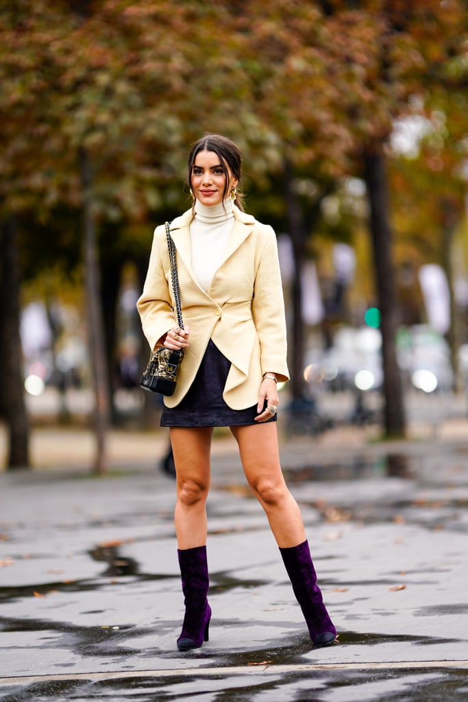 In between seasons, style your mini with a dressy jacket, slim-fitting turtleneck, and mid-calf boots.