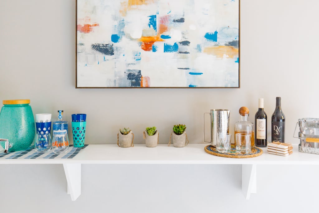 Monica used a bracket shelf to store small decor and created a mini bar — perfect for welcoming guests or taking a break from the tiresome task of folding clothes.