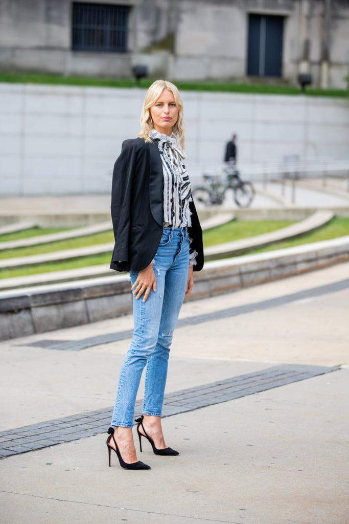 Go for an elevated and elegant denim look with a printed silk blouse, blazer, and heels to finish off the outfit.