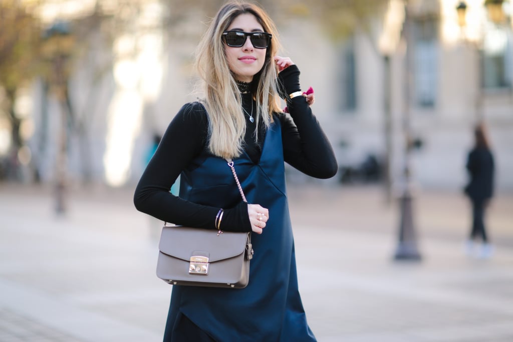 One of the easiest ways to wear this color combo is by layering a black top under your navy dress or vice versa.