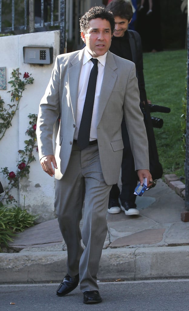 Oscar Nunez wore a gray suit.