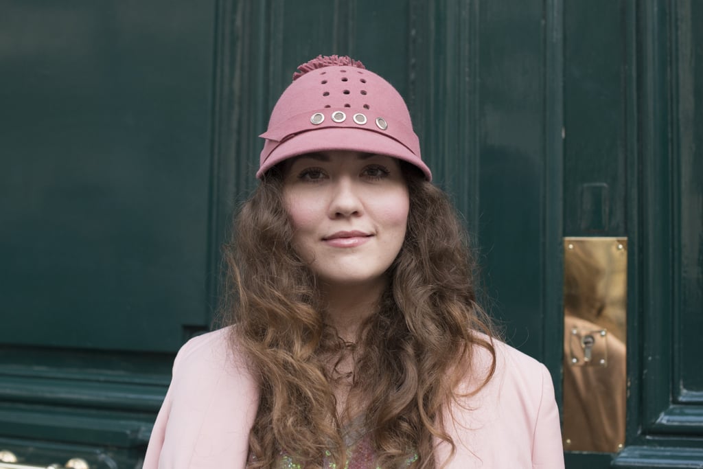 This woman is proof that kinky curls look cute, not crazy, stuffed under a fun cap.