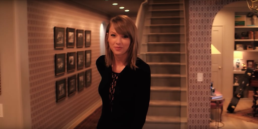 Although you don't get to see the upstairs, Taylor's white staircase and perfectly lined gallery wall are decor goals.