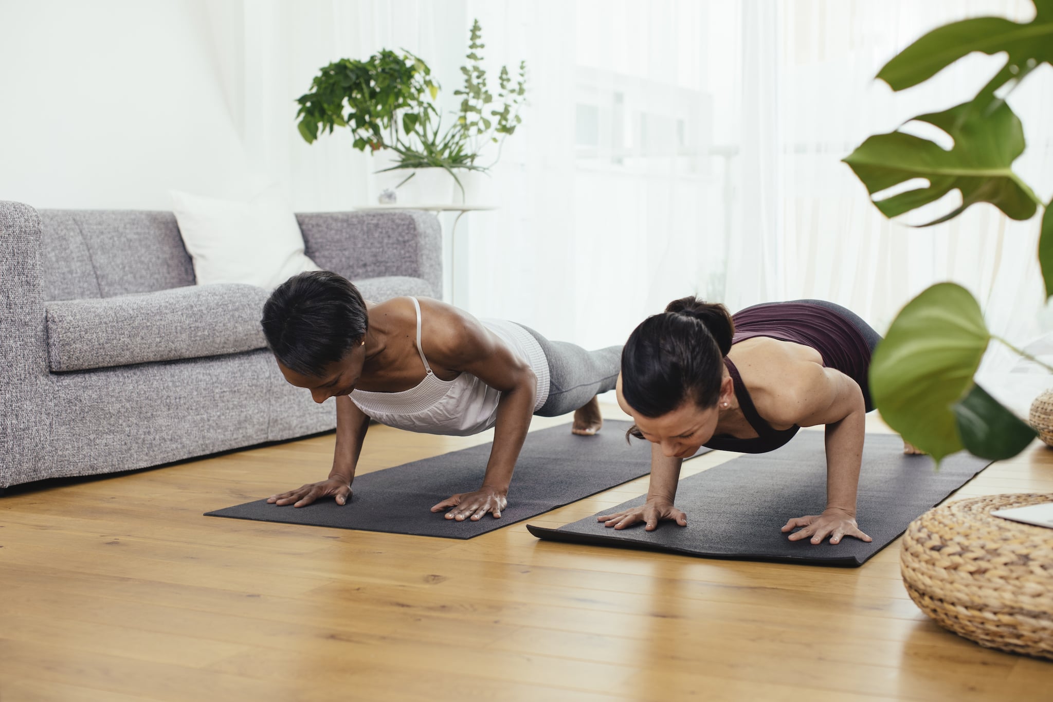 Two women doing gymnastics at home