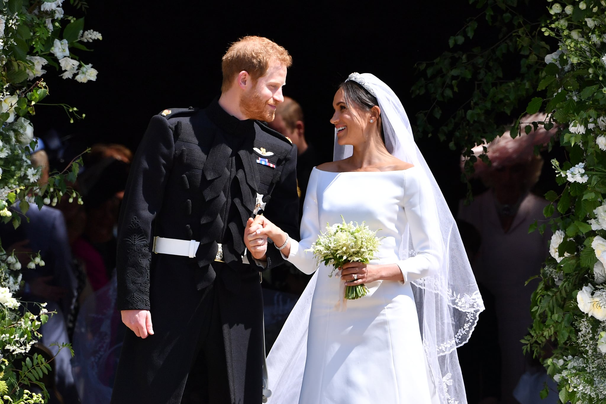 WINDSOR, UNITED KINGDOM - MAY 19: Britain's Prince Harry, Duke of Sussex and his wife Meghan, Duchess of Sussex leave from the West Door of St George's Chapel, Windsor Castle, in Windsor on May 19, 2018 in Windsor, England. (Photo by  Ben STANSALL - WPA Pool/Getty Images)