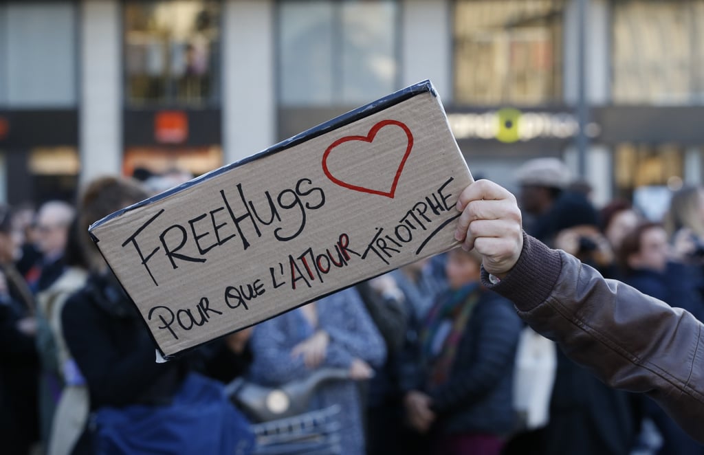 A man held a sign offering free hugs at the Place de la Republique in Paris.