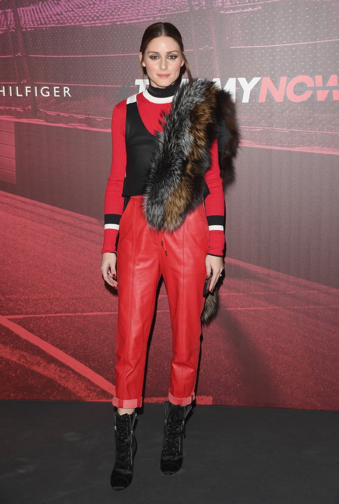 Olivia dressed in all red and accessorized with a furry stole at the Tommy Hilfiger show.