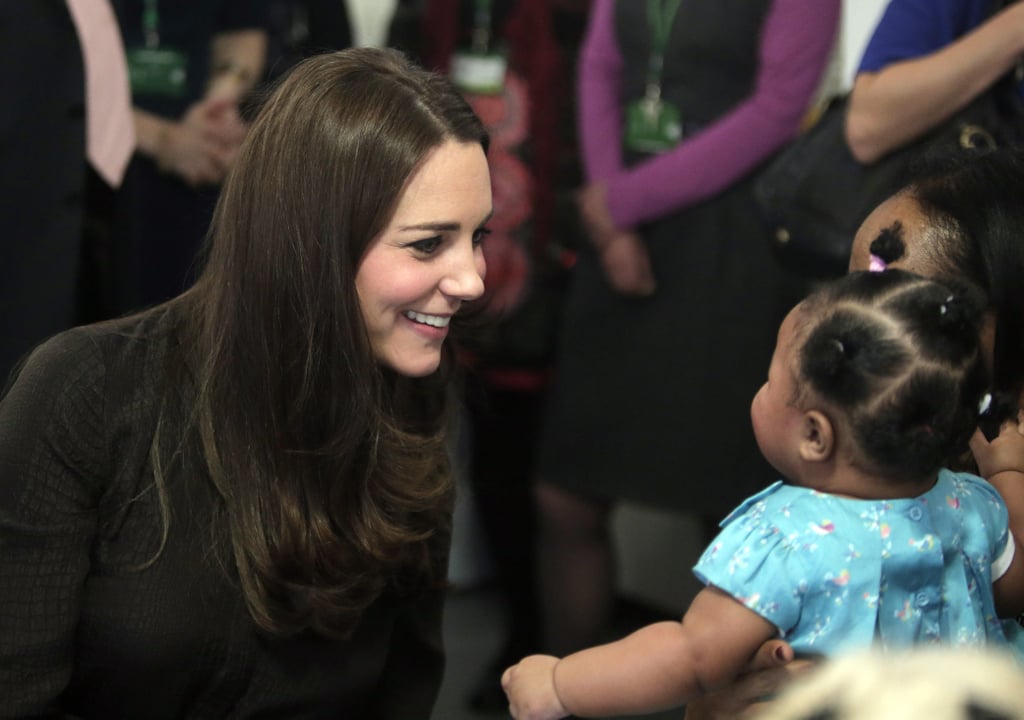 Kate couldn't help but beam while talking to a baby girl at London's Fostering Network event in January 2015.