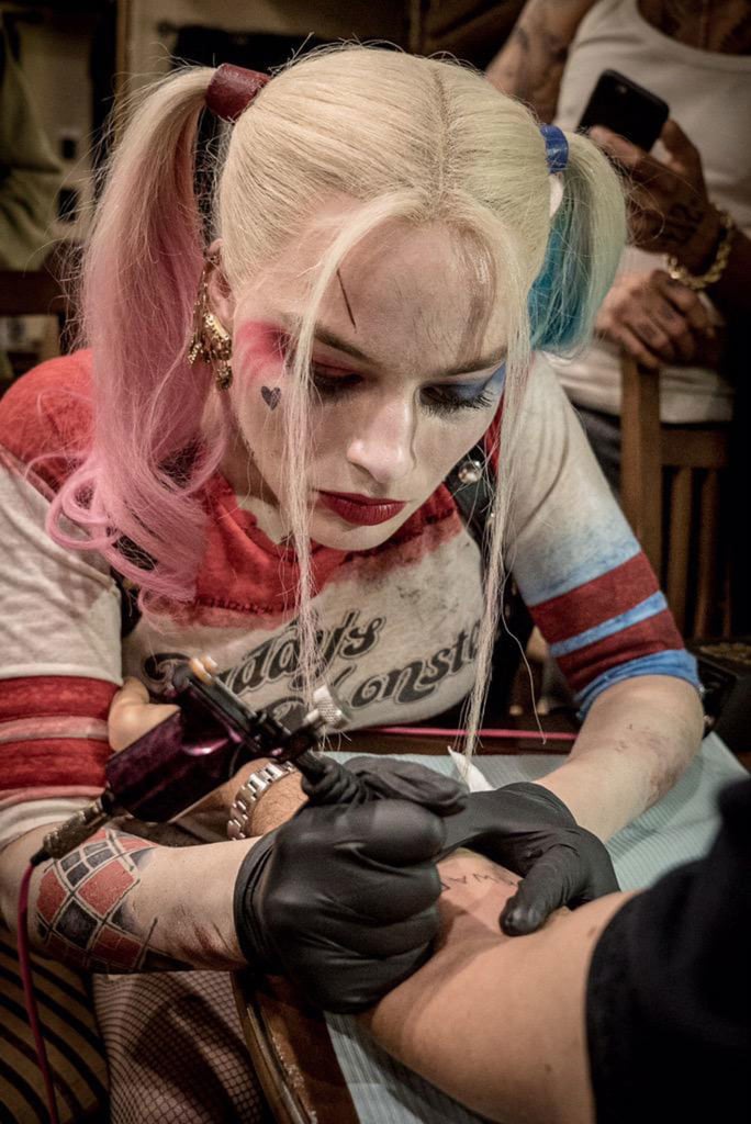 Ayer posted this shot of Robbie as Harley Quinn tattooing someone with the caption "sqwad."