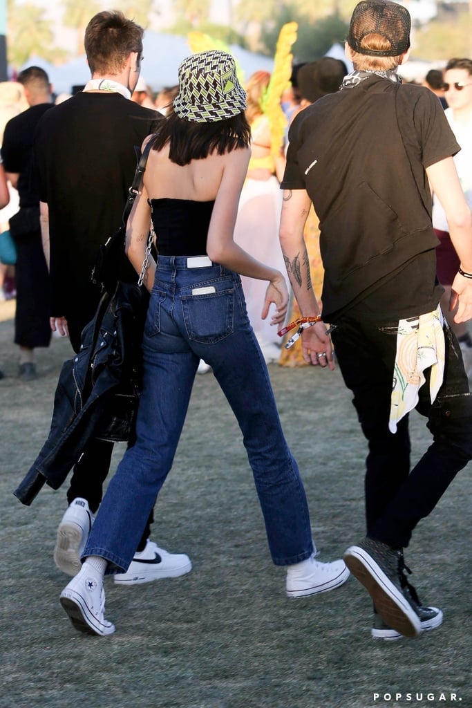 Kaia Gerber Jeans and Tube Top With Bucket Hat at Coachella