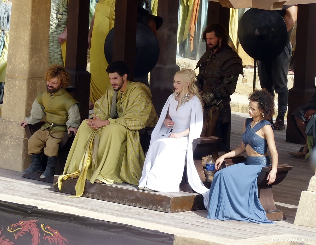 Tyrion (Peter Dinklage) and Daenerys (Emilia Clarke) observe with Missandei (Nathalie Emmanuel) and Daario (Michiel Huisman).