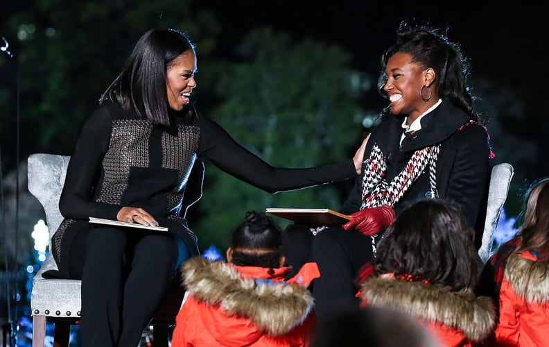 WASHINGTON, DC - DECEMBER 01:  First Lady Michelle Obama (L) and Olympic medal winner Simone Manuel read 